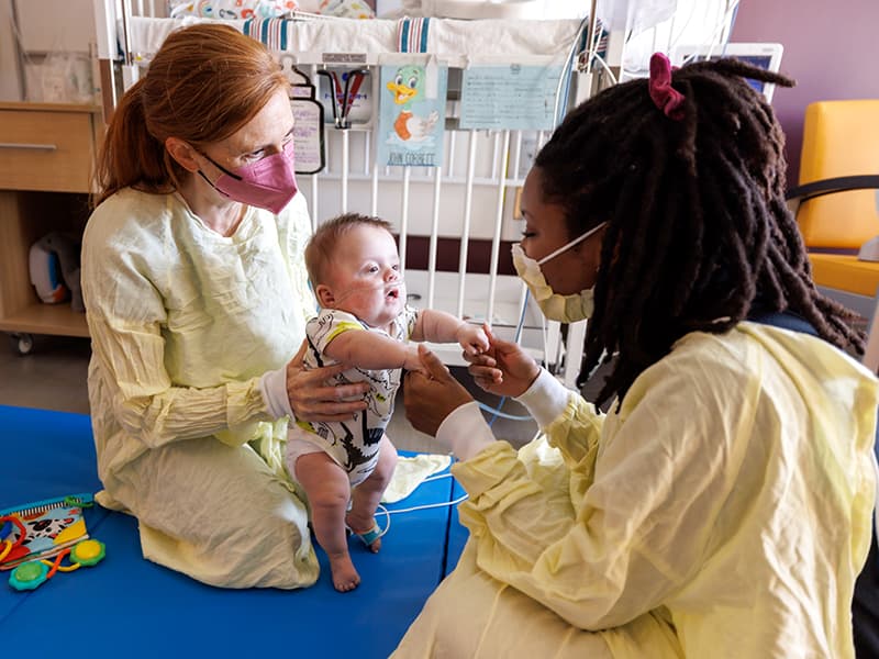John Corbett Bradley of Chunky works on developmental skills with physical therapist Elizabeth Woodcock and occupational therapist Iesha Smith at his neonatal intensive care room inside the Kathy and Joe Sanderson Tower.